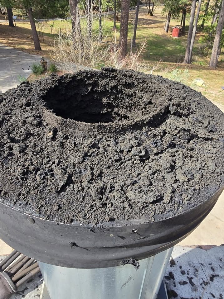 A close look at accumulated soot and creosote inside a spark arrestor.